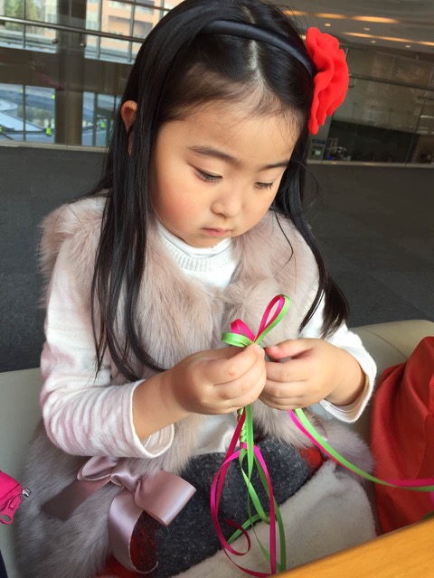 girl making lanyard